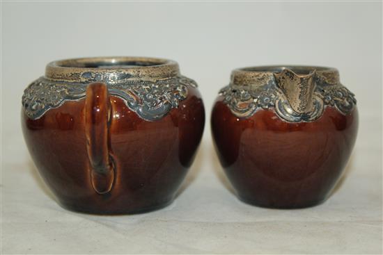 Wedgwood treacle glazed pottery silver mounted part tea set, c.1906, the hot water pot 13cm., one plate broken (13)(-)